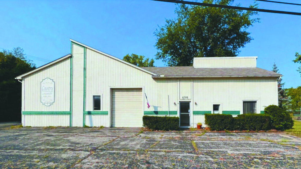 Canna Zoned MLS's Ortonville location, a white building with green accents