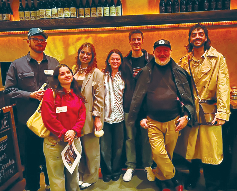 At a CCS alumni event in Brooklyn in 2023, Josie Teachout (in brown suit) and Ava Kaloustian (to her right) reunited with Aki Choklat (front, right).