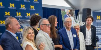Kenneth Eisenberg (in blue suit, third from right) and family at the ground-breaking event in Troy.