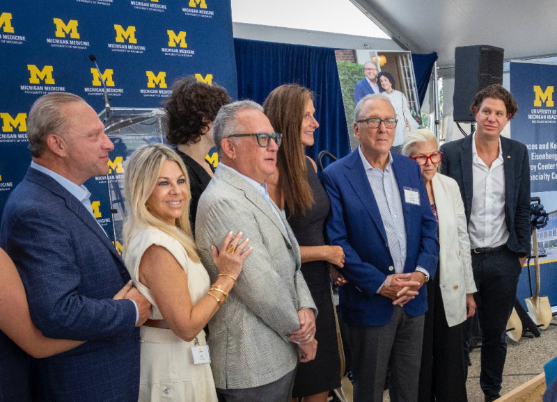 Kenneth Eisenberg (in blue suit, third from right) and family at the ground-breaking event in Troy.