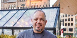 Aramis Torres, a former U.S. Marine and the current executive chef at Lumen, poses in Beacon Park outside the restaurant in downtown Detroit.