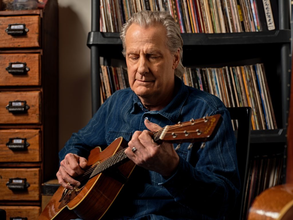 Jeff Daniels playing a guitar