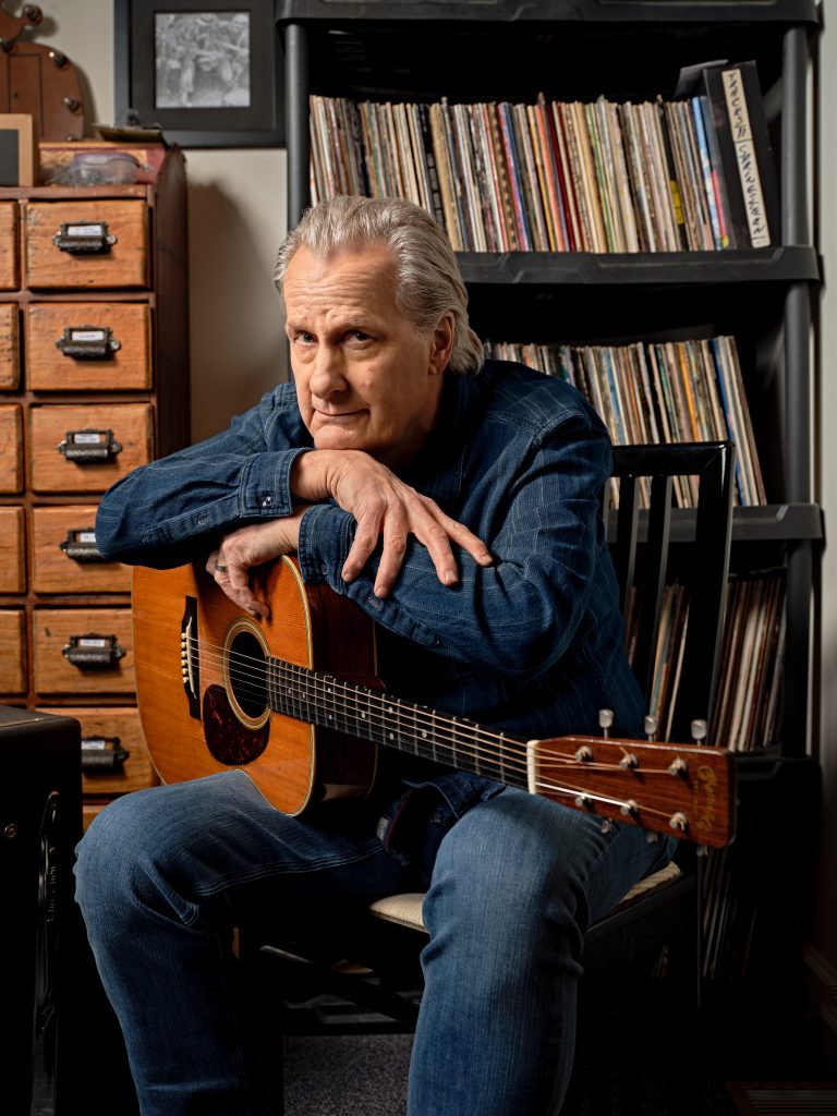 Jeff Daniels posing with a guitar