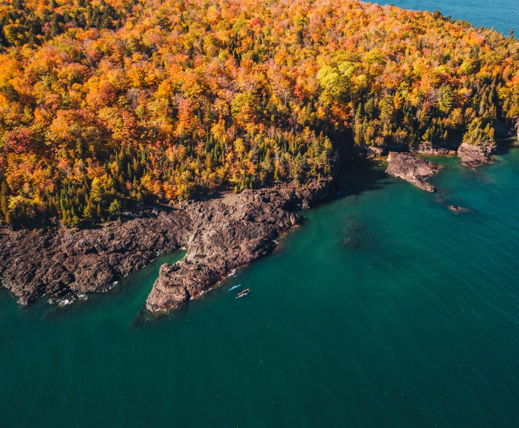 Kayakers paddle near the Blackrocks of Presque Isle Park in Marquette in fall