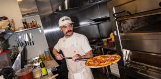Matt Arb holds a pizza at Amelia Street, which opened in June, major dining news in metro Detroit