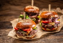 Hour Detroit Editors on What They Look Forward to Trying During Detroit Burger Week Takeaway delivered various types of fresh burgers on rustic wood and recycled paper.