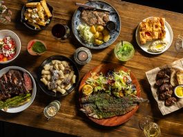 Hour Detroit’s Best New Restaurants 2026: Bar Gabi in Hazel Park Dishes, clockwise from top center: ceafa de pork, Gabriela’s focaccia, mititei, saramura de peste (sea bass), rigatoni, “Vaca Moo” steak,salata de vara, hand-cut fries.