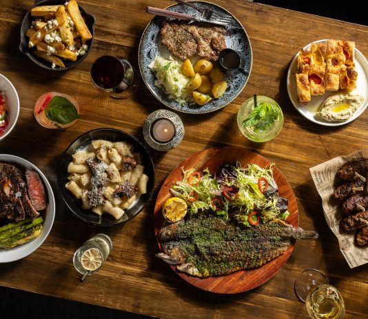 Hour Detroit’s Best New Restaurants 2026: Bar Gabi in Hazel Park Dishes, clockwise from top center: ceafa de pork, Gabriela’s focaccia, mititei, saramura de peste (sea bass), rigatoni, “Vaca Moo” steak,salata de vara, hand-cut fries.
