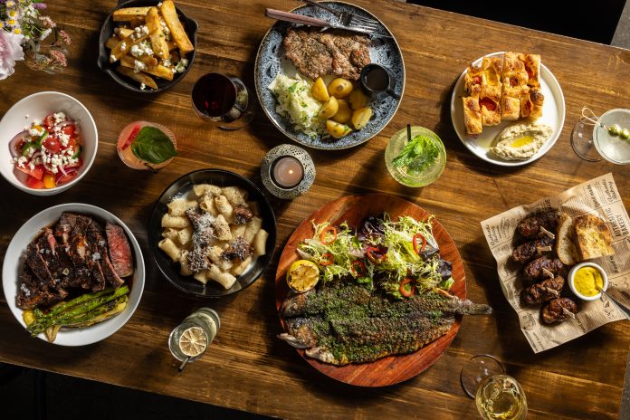 Dishes, clockwise from top center: ceafa de pork, Gabriela’s focaccia, mititei, saramura de peste (sea bass), rigatoni, “Vaca Moo” steak,salata de vara, hand-cut fries.