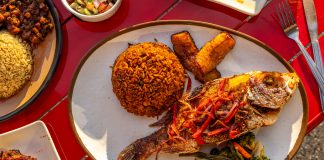 Fried fish with jollof rice, plantains, and roasted vegetables from Little Liberia