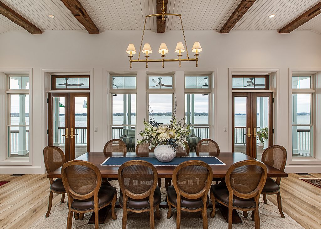 A large dining room with a wood table with 10 seats.