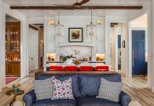 Inside a Gorgeous Waterfront Lenawee County Dream Home by Birch Design Associates A view from the living room inside a large kitchen space, with an island and seating for four.