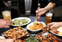 A table full of multiple Detroit-style pizza.