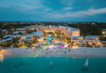 An A-List Escape to Beaches Turks & Caicos An aerial view of Treasure Beach Village during the golden-hour beach party.
