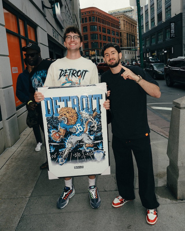 Michael Sana poses with a customer in downtown Detroit