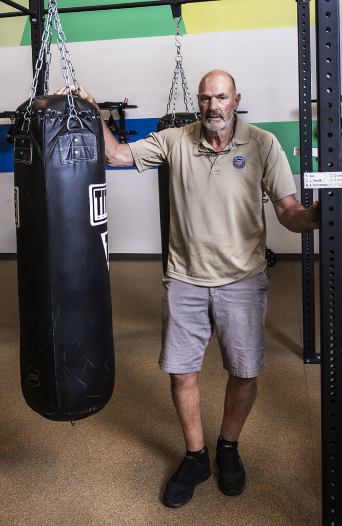 Kirk Gibson standing next to a punching bag
