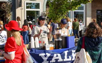 Brighton Brings Stars Hollow to Life for Its Third Annual ‘Gilmore Girls’ Festival A small stand decorated in a Yale flag selling coffee at Destination Starz Hollow in Brighton, Mich.
