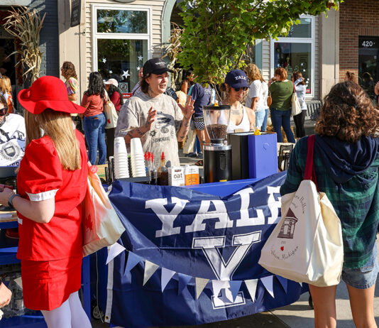 Brighton Brings Stars Hollow to Life for Its Third Annual ‘Gilmore Girls’ Festival A small stand decorated in a Yale flag selling coffee at Destination Starz Hollow in Brighton, Mich.