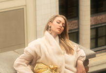 Fall Fashion 2026: Elevated Elegance Model posing in a furry puffer jacket, while holding a gold handbag.
