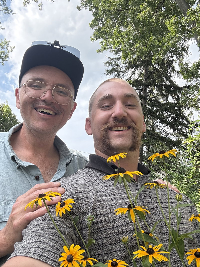Sam Tallent with Hour Detroit's Assistant Editor Will Reaume, who's holding flowers from Tallent's Grosse Pointe Park backyard.