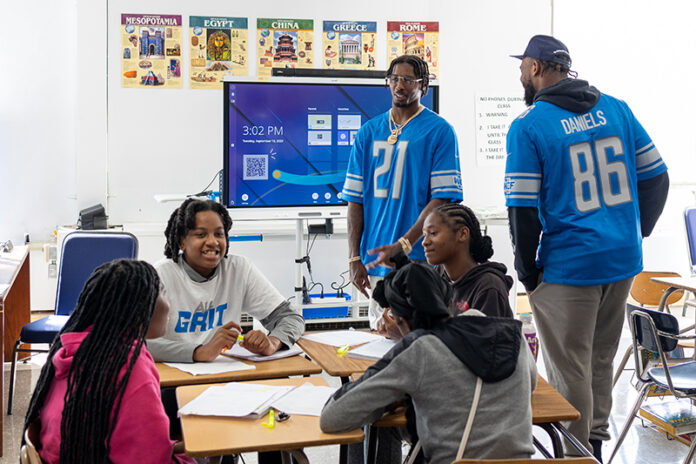R6__2490 Former Lions players Tracy Walker and Darrell Daniels visit with Detroit Lions Academy students.