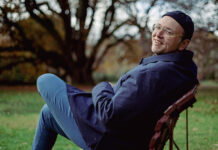 Sam Tallent: The Two-drink Minimum Artist Sam Tallent outdoors, sitting on a chair