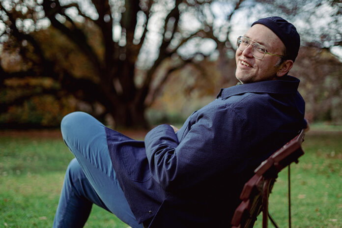 samcolor-2 Sam Tallent outdoors, sitting on a chair