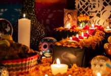 Colorful skull on colorful traditional Day of the Dead "ofrenda"