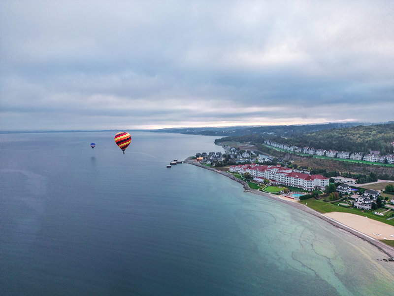 Hot air balloons flying over Bay Harbor.