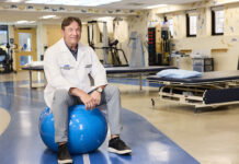 Hour Detroit Top Doc Pano Papalekas, M.D. on Inpatient Rehabilitation Pano Papalekas, M.D. sitting on a balance ball