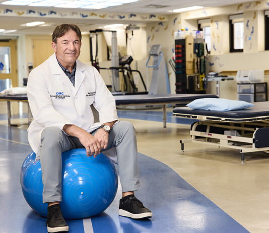 Hour Detroit Top Doc Pano Papalekas, M.D. on Inpatient Rehabilitation Pano Papalekas, M.D. sitting on a balance ball