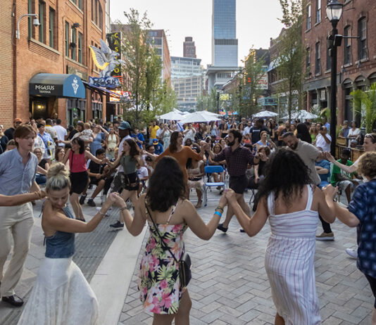 People dancing in the Greektown Monroe Streetscape