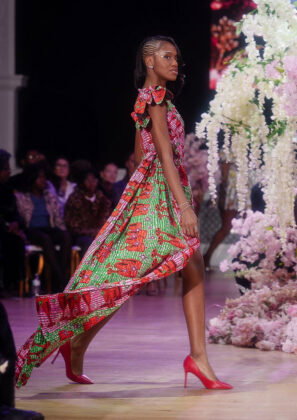 Zapenda: a one-shoulder mini dress with train in a pink and green multi-stripe fabric featuring red champagne flutes